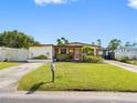Inviting single-story home with green lawn, complemented by lovely landscaping and mailbox at 4532 W Idlewild Ave, Tampa, FL 33614
