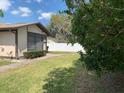 Well-manicured lawn surrounds a charming single-story home with a white privacy fence at 4558 Blossom Blvd # D, Zephyrhills, FL 33542