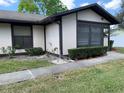 Single-story home with manicured landscaping, neutral exterior paint, and a sidewalk at 4558 Blossom Blvd # D, Zephyrhills, FL 33542