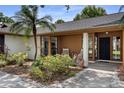 Up close front porch with a landscaped walkway leading to the covered entrance with black door and modern planters at 4715 Kemble Ct, Tampa, FL 33624