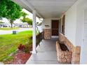 Inviting covered porch with stone accents and decorative columns, offering a cozy entrance at 7435 Hollyridge Dr, New Port Richey, FL 34653