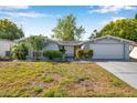 Charming single-story home featuring a well-maintained lawn and attached two-car garage at 7824 Blackstone Dr, Port Richey, FL 34668