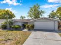 Charming single-story home featuring a well-maintained lawn and attached two-car garage at 7824 Blackstone Dr, Port Richey, FL 34668