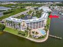Waterfront resort-style complex featuring a pool, landscaping, and stunning water views at 8800 Bay Pines Blvd # 318, St Petersburg, FL 33709