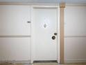 Condo front door displaying apartment number, knocker, hardware, and adjacent molding details at 1 Key Capri # 301E, Treasure Island, FL 33706