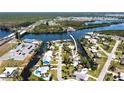 An aerial view displays the home's placement in a serene neighborhood on the water at 112 Gause Dr, Venice, FL 34293