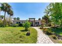 Charming single-story home featuring a landscaped front yard and inviting walkway leading to the entrance at 112 Gause Dr, Venice, FL 34293