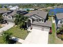 Beautiful home with a three-car garage, meticulously manicured landscaping, and solar panels at 11416 Carlton Fields Dr, Riverview, FL 33579