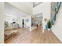 Bright foyer with an open floor plan, hardwood floors, neutral paint, and high ceilings at 11416 Carlton Fields Dr, Riverview, FL 33579