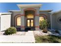 Welcoming front entrance with double doors, transom window, and accent lighting at 14296 Pullman Dr, Spring Hill, FL 34609