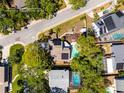 Aerial view of the property with a backyard pool, wooden deck, mature trees, and clearly marked boundaries at 14323 83Rd Pl, Seminole, FL 33776