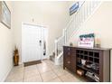 Inviting foyer with neutral walls, decorative furniture, and a view of the staircase at 1564 Imperial Key Dr, Trinity, FL 34655