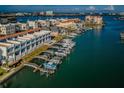 Aerial view shows condos with boat docks and a serene water view; coastal living at its finest at 161 Brightwater Dr # 8, Clearwater Beach, FL 33767