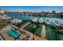 Relaxing pool area with waterfront views, docks, and boats creating an ideal setting for leisure and recreation at 161 Brightwater Dr # 8, Clearwater Beach, FL 33767