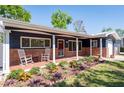Charming front porch with rocking chairs and brick accents, perfect for enjoying the outdoors at 2019 Inner S Cir, St Petersburg, FL 33712