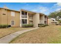 Exterior of the condo building with manicured landscaping, walkway, and community gazebo at 209 Lake Brook Cir # 104, Brandon, FL 33511