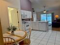 Bright kitchen features white cabinets, tile flooring, and a breakfast nook perfect for casual dining at 224 Chardonnay Pl, Valrico, FL 33594