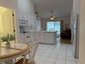 Bright eat-in kitchen features white cabinetry, modern appliances, and sliding glass door to the patio at 224 Chardonnay Pl, Valrico, FL 33594