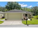 View of the home's exterior showcasing its neutral stucco, attached garage, and driveway at 29250 Princeville Dr, San Antonio, FL 33576