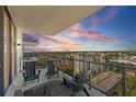 Relaxing balcony featuring outdoor seating and a beautiful sunset view, ideal for enjoying serene evenings at 301 1St S St # 2205, St Petersburg, FL 33701