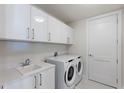 Well-organized laundry room with modern washer, dryer, and ample storage cabinets for convenience at 301 1St S St # 2205, St Petersburg, FL 33701
