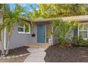 Charming front door with tropical landscaping and a well-maintained walkway at 320 Lake Maggiore S Blvd, St Petersburg, FL 33705