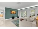 Bright living room featuring double doors to the outside, and view of the kitchen with modern lighting at 320 Lake Maggiore S Blvd, St Petersburg, FL 33705