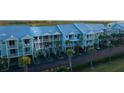 Exterior view of a multi-story condo complex with balconies and palm trees at 3210 Mangrove Point Dr, Ruskin, FL 33570