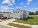Attractive two-story house showcases a two-car garage, light blue shutters, and a neatly landscaped front yard at 35168 Arya Way, Zephyrhills, FL 33541