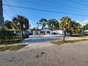 Charming single-story home boasts a spacious parking area, fresh exterior paint, and a welcoming orange front door at 4119 W Nassau St, Tampa, FL 33607