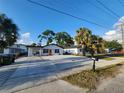 Charming single-story home boasts a spacious parking area, fresh exterior paint, and a welcoming orange front door at 4119 W Nassau St, Tampa, FL 33607