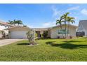 Charming home with a well-maintained front lawn and mature landscaping at 4544 Harbor Hills Dr, Largo, FL 33770