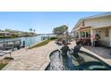 Inviting outdoor living space featuring a built-in pool and views of the bay at 4544 Harbor Hills Dr, Largo, FL 33770