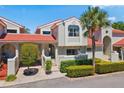 Inviting two-story townhome showcasing a terra cotta roof and beautifully maintained grounds at 4859 Napoli Ne Ct # 4859, St Petersburg, FL 33703