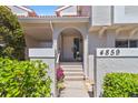 Welcoming front entrance with tiled steps and lush landscaping at 4859 Napoli Ne Ct # 4859, St Petersburg, FL 33703