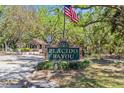 Community entrance sign for Placido Bayou with American flag at 4859 Napoli Ne Ct # 4859, St Petersburg, FL 33703