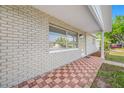 Close up view of covered front porch and red brick pattern floor at 5200 52Nd N Ave, St Petersburg, FL 33709
