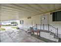 Covered carport entry provides convenient access to the home, featuring a small porch and minimal landscaping at 5832 Sussex Dr, Tampa, FL 33615