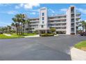 A beautiful multi-story building with palm trees and lush landscaping situated in a sunny location at 8020 Sailboat Key S Blvd # 101, St Pete Beach, FL 33707