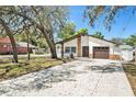 Charming single-story home with stone accents, a two-car garage, and a well-maintained front yard at 8902 N Hamner Ave, Tampa, FL 33604