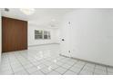 Spacious living room featuring stylish wall accents, tile flooring, and ample natural light from the window at 8902 N Hamner Ave, Tampa, FL 33604