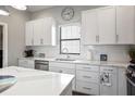 Kitchen featuring white cabinets, stainless steel appliances, quartz countertops, and breakfast bar at 946 Highland Ave # 23, Dunedin, FL 34698