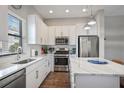 Bright kitchen featuring white cabinets, stainless steel appliances, quartz countertops, and center island at 946 Highland Ave # 23, Dunedin, FL 34698