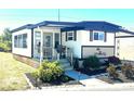 Charming single-story home with a covered front porch, landscaped yard and carport at 9790 66Th N St # 346, Pinellas Park, FL 33782
