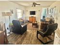 Cozy living room featuring comfortable seating, natural light, and wood-look flooring at 9790 66Th N St # 346, Pinellas Park, FL 33782