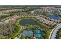 Beautiful community with tennis courts and a pond from an aerial view at 11414 Juglans Dr, Odessa, FL 33556