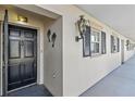Condominium entrance with decorative door and exterior lighting at 131 Bluff View Dr # 101, Belleair Bluffs, FL 33770