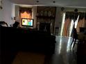 Cozy living room features tiled floors, stone fireplace, and large windows at 1312 Foxboro Dr., Brandon, FL 33511