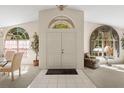 Bright entryway with soaring ceilings, arched windows, and tile flooring at 15014 Arbor Hollow Dr, Odessa, FL 33556