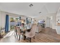 Open-concept dining area with large sliding doors and a modern table set perfect for entertaining at 1849 Diane Dr, Clearwater, FL 33759